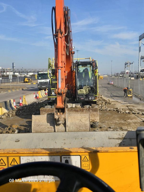 Excavator performing demolition at port