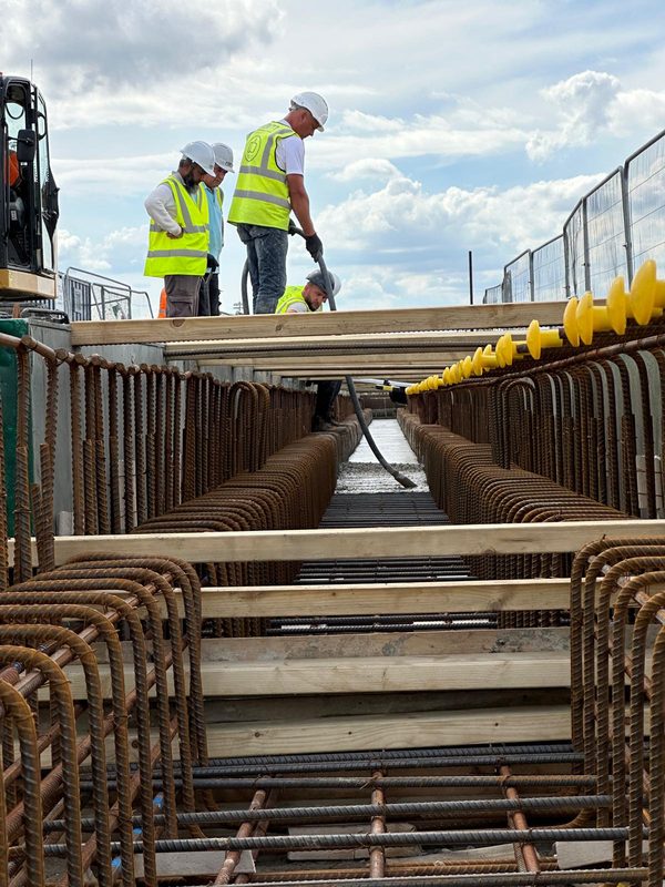 Workers constructing rebar cage at port site