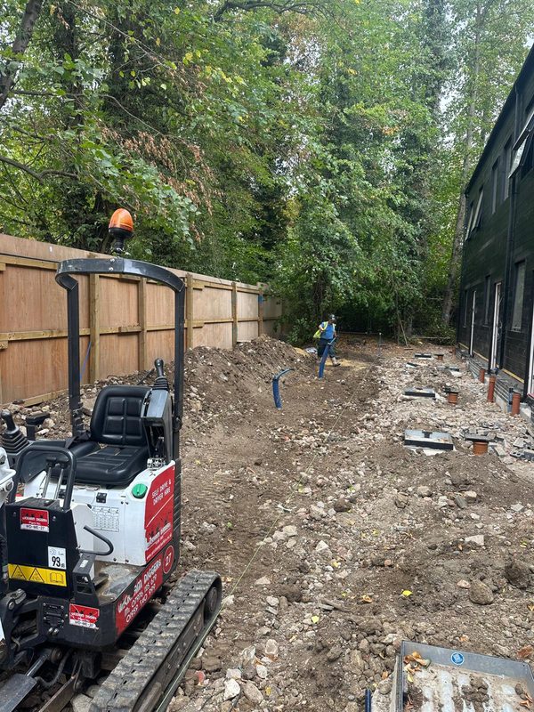 Mini digger on residential groundworks site